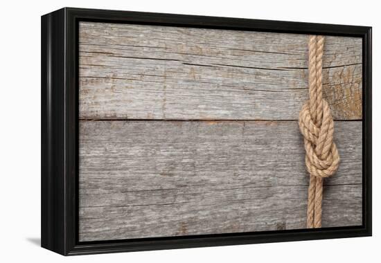 Ship Rope Knot on Old Wooden Texture Background-karandaev-Framed Premier Image Canvas