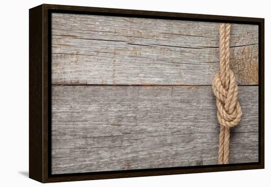 Ship Rope Knot on Old Wooden Texture Background-karandaev-Framed Premier Image Canvas