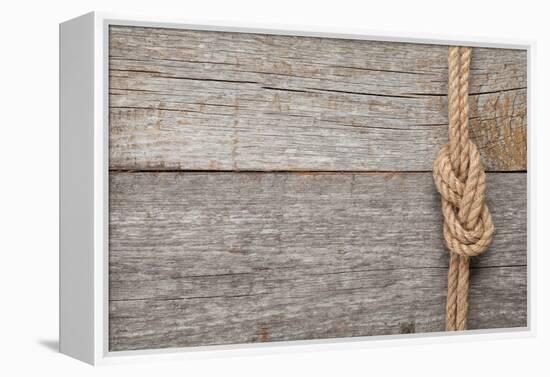 Ship Rope Knot on Old Wooden Texture Background-karandaev-Framed Premier Image Canvas