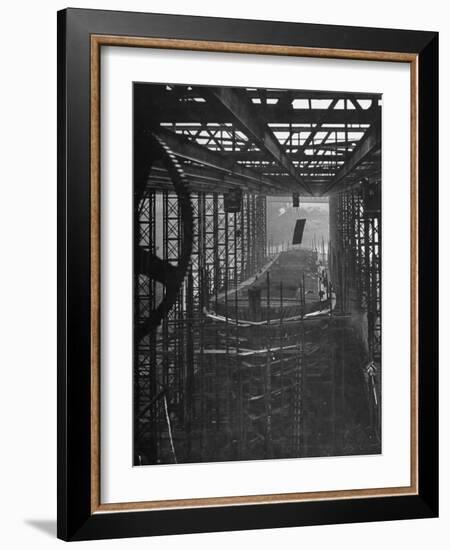 Shipbuilding, 10,000 Ton Merchantman Frames on Overhead Trolley Crane Dropping Plate into Position-William Vandivert-Framed Photographic Print