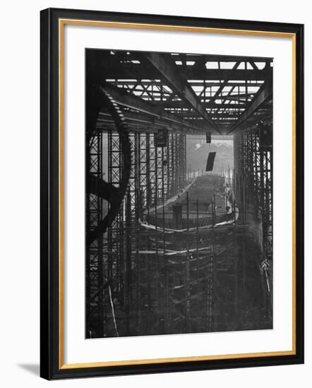 Shipbuilding, 10,000 Ton Merchantman Frames on Overhead Trolley Crane Dropping Plate into Position-William Vandivert-Framed Photographic Print