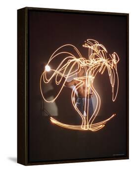 Shirtless Artist Pablo Picasso Creating Light Drawing of Vase of Flowers-Gjon Mili-Framed Premier Image Canvas