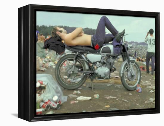 Shirtless Man in Levi Strauss Jeans Lying on Motorcycle Seat at Woodstock Music Festival-Bill Eppridge-Framed Premier Image Canvas