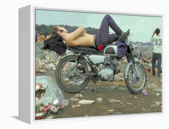 Shirtless Man in Levi Strauss Jeans Lying on Motorcycle Seat at Woodstock Music Festival-Bill Eppridge-Framed Premier Image Canvas