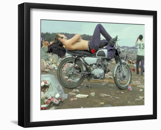 Shirtless Man in Levi Strauss Jeans Lying on Motorcycle Seat at Woodstock Music Festival-Bill Eppridge-Framed Photographic Print