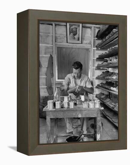 Shoemaker Sitting in His Shop Working on a Pair of Old Work Shoes-John Phillips-Framed Premier Image Canvas