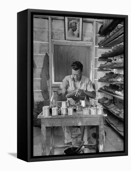 Shoemaker Sitting in His Shop Working on a Pair of Old Work Shoes-John Phillips-Framed Premier Image Canvas