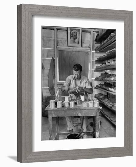 Shoemaker Sitting in His Shop Working on a Pair of Old Work Shoes-John Phillips-Framed Photographic Print
