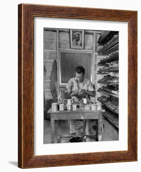 Shoemaker Sitting in His Shop Working on a Pair of Old Work Shoes-John Phillips-Framed Photographic Print