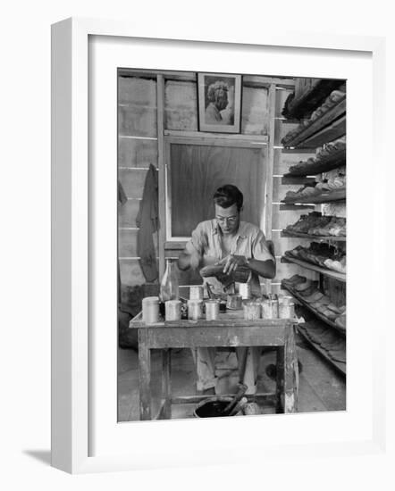 Shoemaker Sitting in His Shop Working on a Pair of Old Work Shoes-John Phillips-Framed Photographic Print