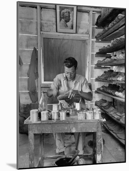 Shoemaker Sitting in His Shop Working on a Pair of Old Work Shoes-John Phillips-Mounted Photographic Print