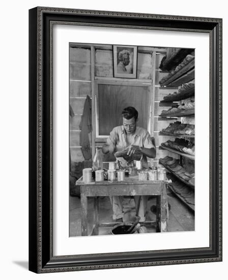 Shoemaker Sitting in His Shop Working on a Pair of Old Work Shoes-John Phillips-Framed Photographic Print