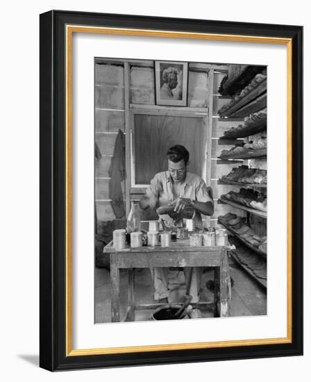 Shoemaker Sitting in His Shop Working on a Pair of Old Work Shoes-John Phillips-Framed Photographic Print