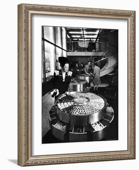 Shopper Looking at Selection of Chocolates in Elegant Fifth Avenue Candy Store-Alfred Eisenstaedt-Framed Photographic Print