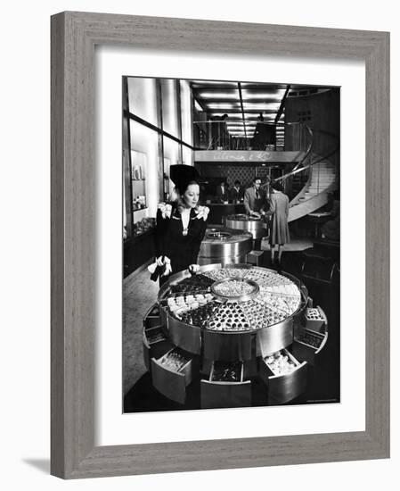 Shopper Looking at Selection of Chocolates in Elegant Fifth Avenue Candy Store-Alfred Eisenstaedt-Framed Photographic Print