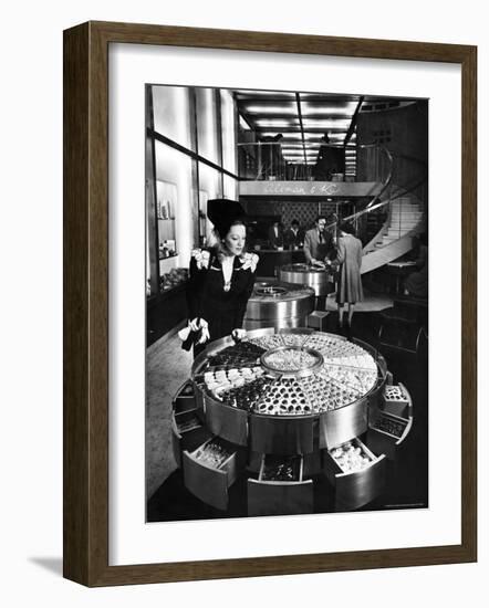 Shopper Looking at Selection of Chocolates in Elegant Fifth Avenue Candy Store-Alfred Eisenstaedt-Framed Photographic Print