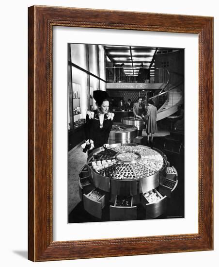 Shopper Looking at Selection of Chocolates in Elegant Fifth Avenue Candy Store-Alfred Eisenstaedt-Framed Photographic Print