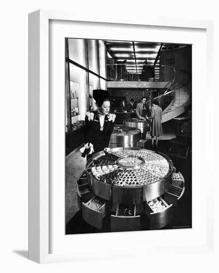 Shopper Looking at Selection of Chocolates in Elegant Fifth Avenue Candy Store-Alfred Eisenstaedt-Framed Photographic Print