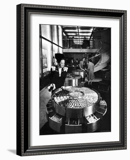 Shopper Looking at Selection of Chocolates in Elegant Fifth Avenue Candy Store-Alfred Eisenstaedt-Framed Photographic Print