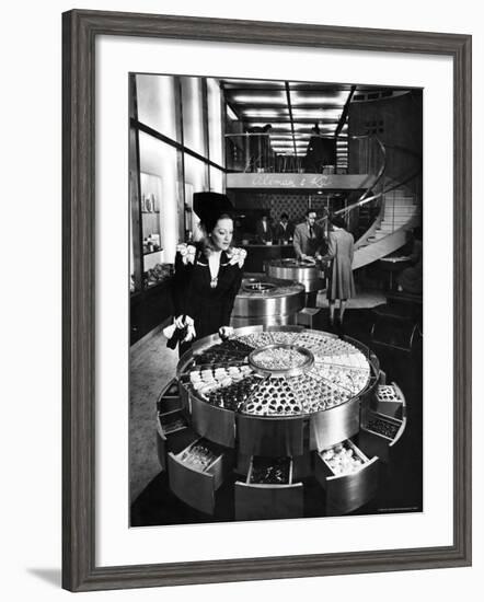 Shopper Looking at Selection of Chocolates in Elegant Fifth Avenue Candy Store-Alfred Eisenstaedt-Framed Photographic Print