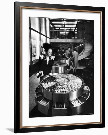 Shopper Looking at Selection of Chocolates in Elegant Fifth Avenue Candy Store-Alfred Eisenstaedt-Framed Photographic Print