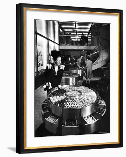 Shopper Looking at Selection of Chocolates in Elegant Fifth Avenue Candy Store-Alfred Eisenstaedt-Framed Photographic Print