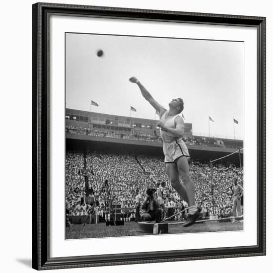 Shot Putter Francis Delaney in Mid-Throw in an Attempt to Qualify During the U.S. Olympic Tryouts-Ed Clark-Framed Premium Photographic Print