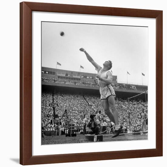 Shot Putter Francis Delaney in Mid-Throw in an Attempt to Qualify During the U.S. Olympic Tryouts-Ed Clark-Framed Premium Photographic Print
