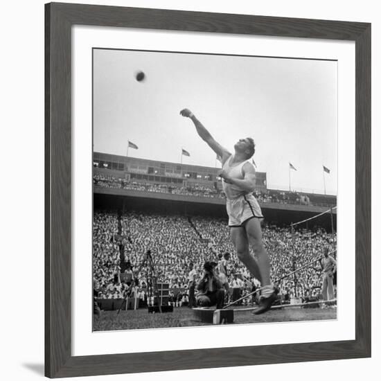 Shot Putter Francis Delaney in Mid-Throw in an Attempt to Qualify During the U.S. Olympic Tryouts-Ed Clark-Framed Premium Photographic Print