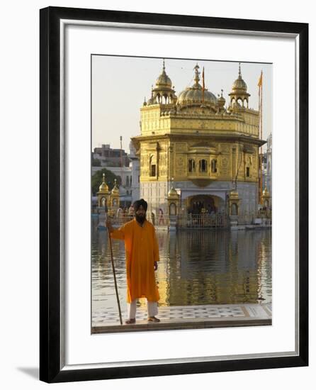 Shrine Guard in Orange Clothes Holding Lance Standing by Pool in Front of the Golden Temple-Eitan Simanor-Framed Photographic Print