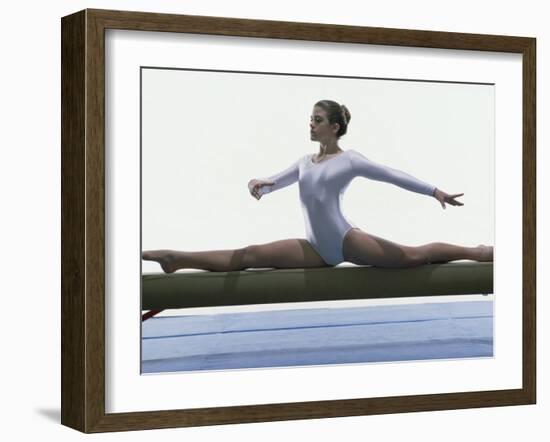 Side Profile of a Female Gymnast Stretching on a Balance Beam-null-Framed Photographic Print