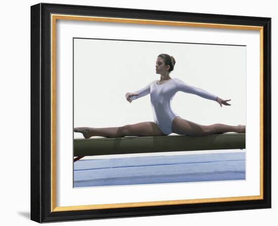 Side Profile of a Female Gymnast Stretching on a Balance Beam-null-Framed Photographic Print