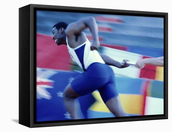 Side Profile of Runners Passing a Baton in a Relay Race-null-Framed Premier Image Canvas
