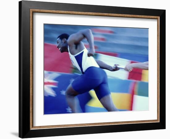 Side Profile of Runners Passing a Baton in a Relay Race-null-Framed Photographic Print