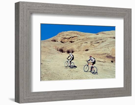 Side profile of two men mountain bilking on rocks, Slickrock Trail, Moab, Utah, USA-Richard Sisk-Framed Photographic Print