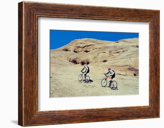 Side profile of two men mountain bilking on rocks, Slickrock Trail, Moab, Utah, USA-Richard Sisk-Framed Photographic Print