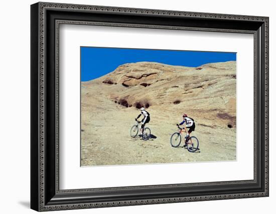 Side profile of two men mountain bilking on rocks, Slickrock Trail, Moab, Utah, USA-Richard Sisk-Framed Photographic Print