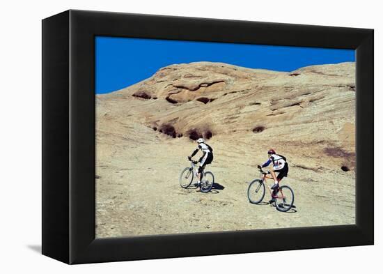 Side profile of two men mountain bilking on rocks, Slickrock Trail, Moab, Utah, USA-Richard Sisk-Framed Premier Image Canvas