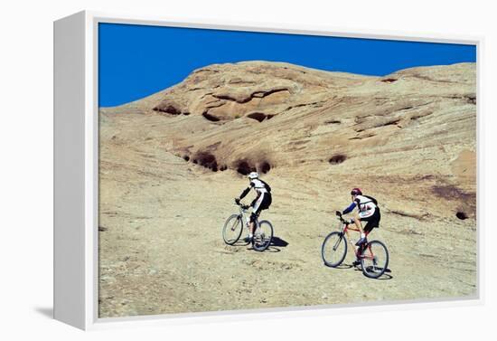 Side profile of two men mountain bilking on rocks, Slickrock Trail, Moab, Utah, USA-Richard Sisk-Framed Premier Image Canvas