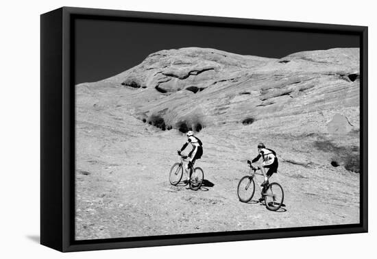Side profile of two men mountain bilking on rocks, Slickrock Trail, Moab, Utah, USA-Richard Sisk-Framed Premier Image Canvas