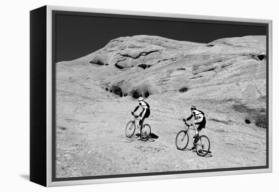 Side profile of two men mountain bilking on rocks, Slickrock Trail, Moab, Utah, USA-Richard Sisk-Framed Premier Image Canvas