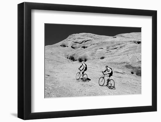 Side profile of two men mountain bilking on rocks, Slickrock Trail, Moab, Utah, USA-Richard Sisk-Framed Photographic Print