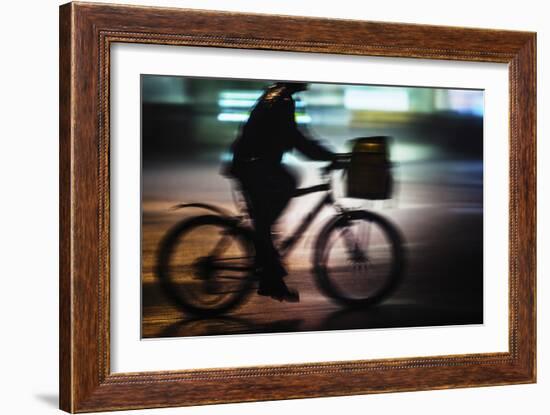 Side View With Motion Blur Of A Delivery Man Riding A Bicycle At Night In Downtown Manhattan-Ron Koeberer-Framed Photographic Print