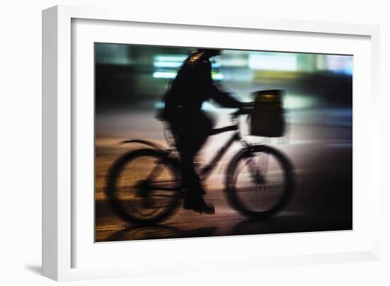 Side View With Motion Blur Of A Delivery Man Riding A Bicycle At Night In Downtown Manhattan-Ron Koeberer-Framed Photographic Print