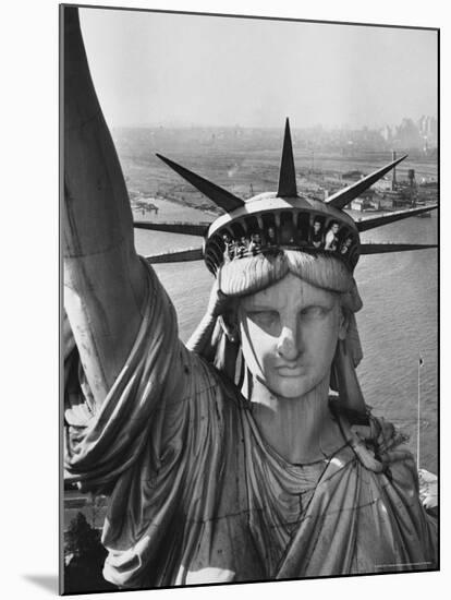 Sightseers Hanging Out Windows in Crown of Statue of Liberty with NJ Shore in the Background-Margaret Bourke-White-Mounted Premium Photographic Print