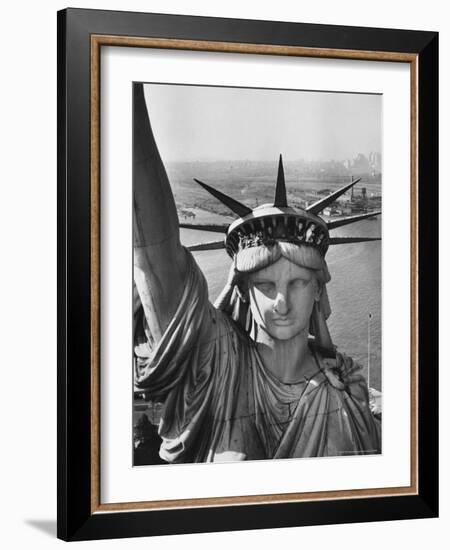 Sightseers Hanging Out Windows in Crown of Statue of Liberty with NJ Shore in the Background-Margaret Bourke-White-Framed Photographic Print