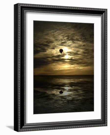 Silhouette of a Hot Air Balloon Over Water-null-Framed Photographic Print