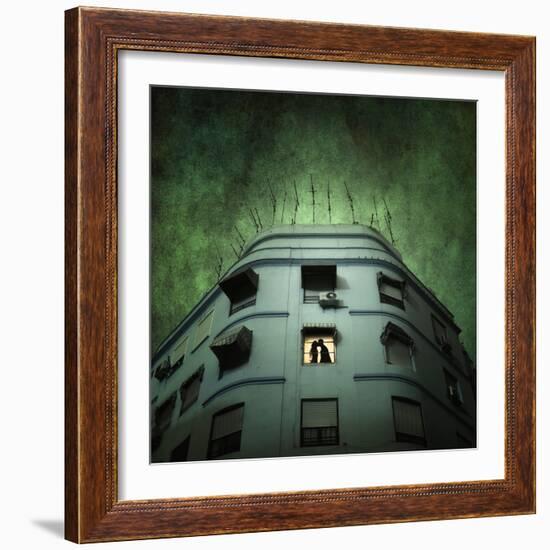 Silhouette of a Man and Woman Kissing in a Window of a Large Building with TV Ariels on the Roof-Luis Beltran-Framed Photographic Print
