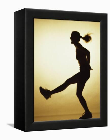 Silhouette of a Young Woman Exercising-null-Framed Premier Image Canvas