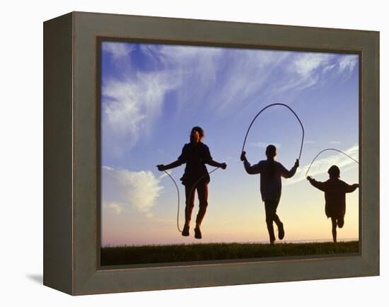 Silhouette of Children Jumping Rope Outdoors-Mitch Diamond-Framed Premier Image Canvas